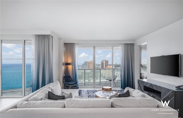 living room featuring plenty of natural light and a water view