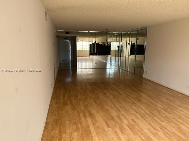 empty room featuring a textured ceiling and hardwood / wood-style flooring