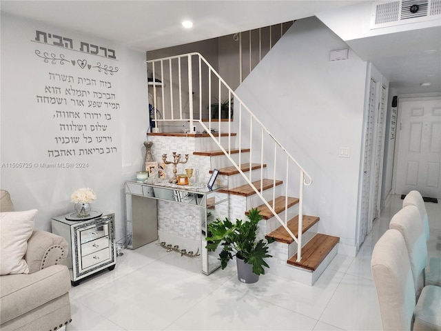 stairs featuring tile patterned flooring