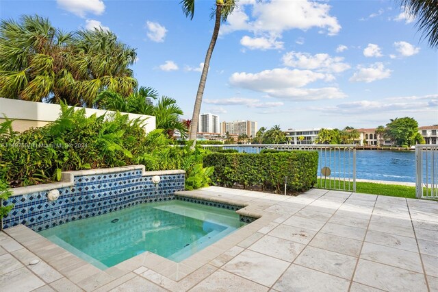 view of swimming pool with an in ground hot tub