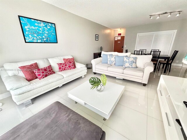 living room featuring light tile patterned floors and a textured ceiling