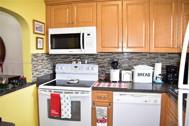 kitchen with backsplash and white appliances