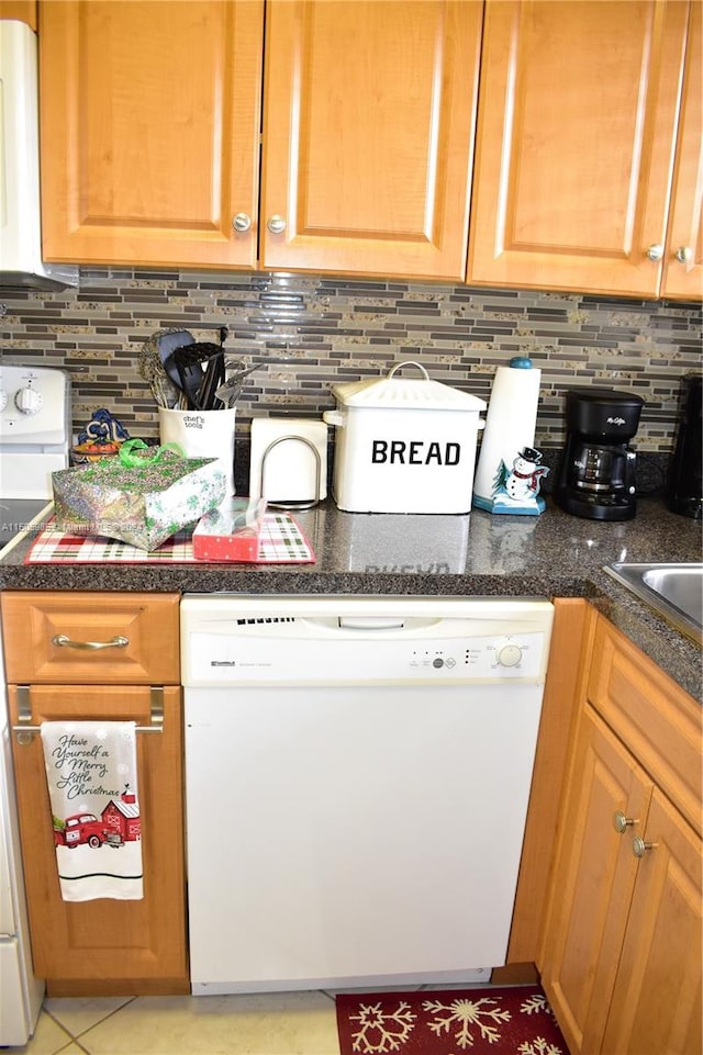 kitchen with backsplash, white dishwasher, range, and light tile flooring