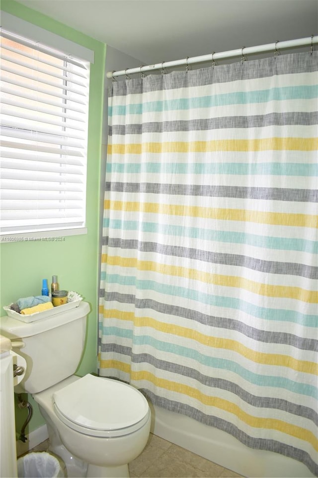 bathroom featuring toilet and tile floors