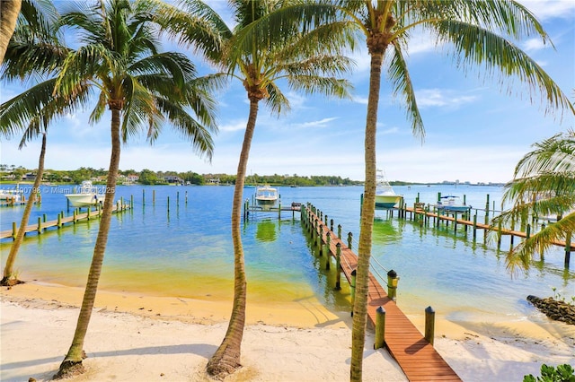 dock area with a water view and a view of the beach