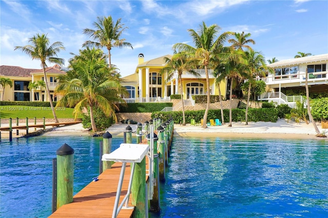 view of dock featuring a balcony and a water view