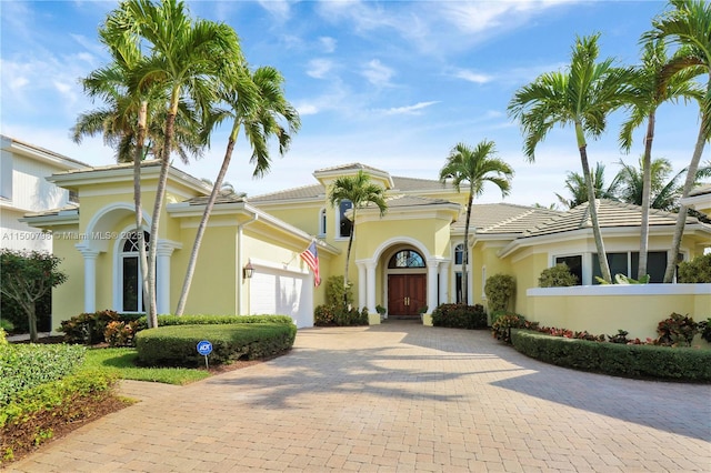 mediterranean / spanish-style house with a garage