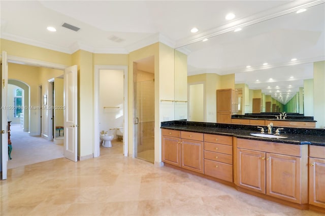 bathroom featuring vanity, a bidet, ornamental molding, and an enclosed shower