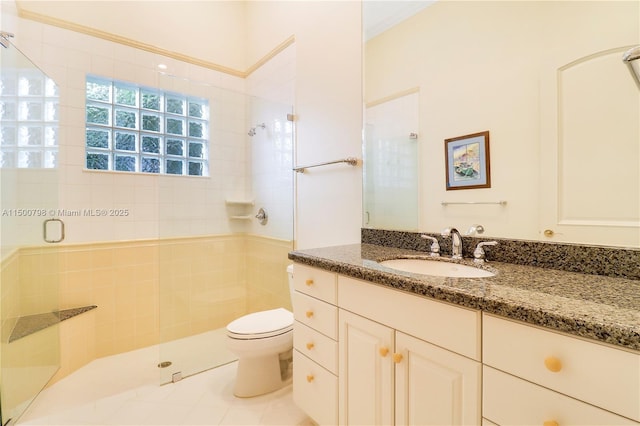 bathroom featuring vanity, an enclosed shower, tile patterned floors, and toilet