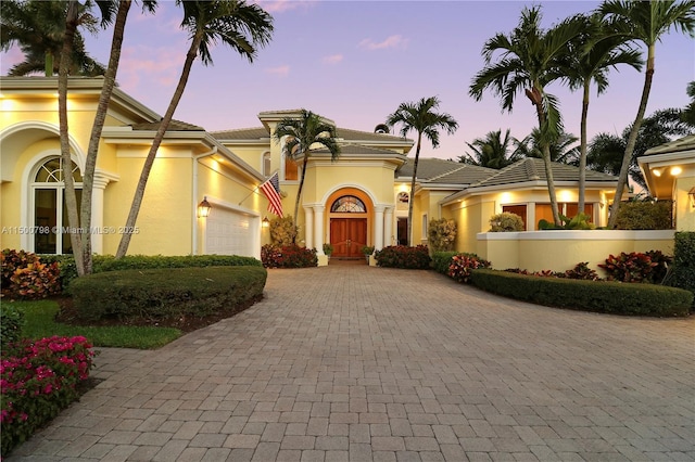 mediterranean / spanish home featuring a garage