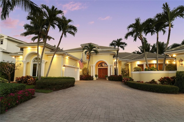 mediterranean / spanish house featuring a garage