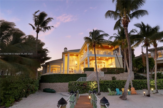 view of front of house featuring a patio and a balcony