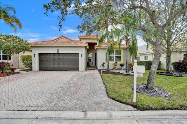 mediterranean / spanish-style home with a garage and a front yard