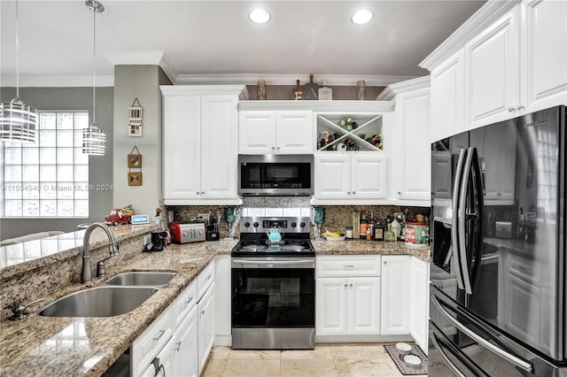 kitchen featuring light stone countertops, appliances with stainless steel finishes, crown molding, sink, and white cabinets