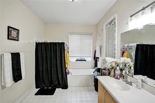 bathroom with a tub to relax in, vanity, and tile patterned flooring