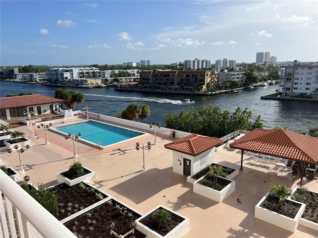 view of swimming pool with a gazebo, a water view, and a patio area