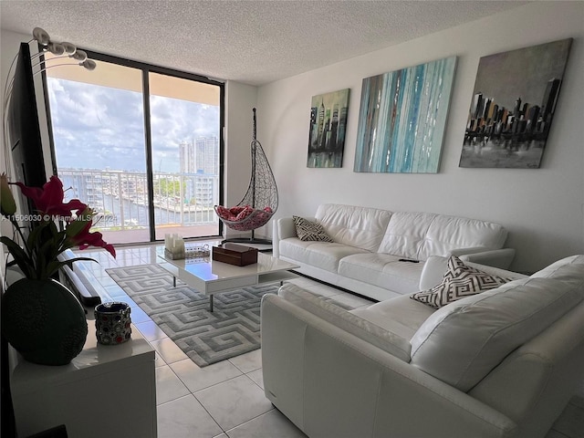 living room featuring floor to ceiling windows, a textured ceiling, and light tile patterned floors