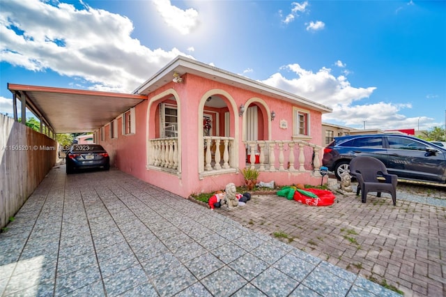 854 E 24th St, Hialeah, FL 33013 - view of front of home featuring fence, driveway, and a carport
