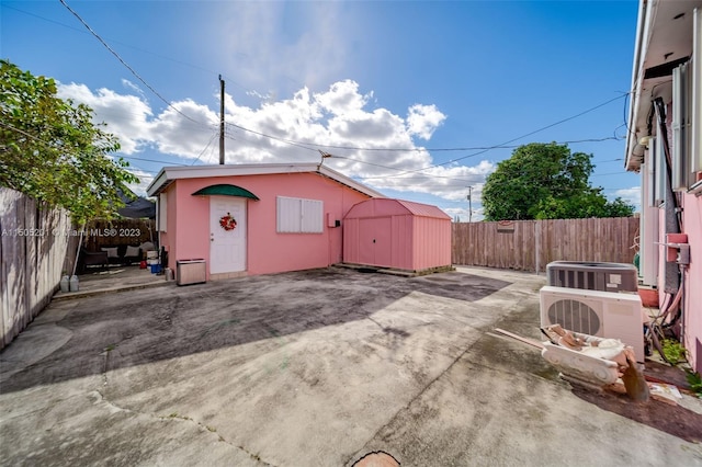 854 E 24th St, Hialeah, FL 33013 - view of shed with a fenced backyard and central AC unit