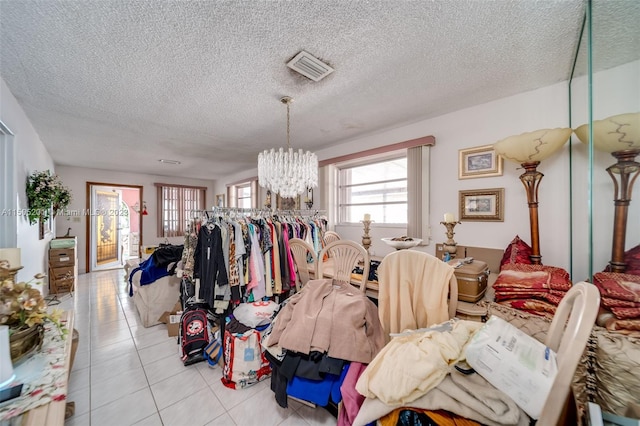 854 E 24th St, Hialeah, FL 33013 - dining space featuring visible vents, a textured ceiling, a notable chandelier, and light tile patterned floors