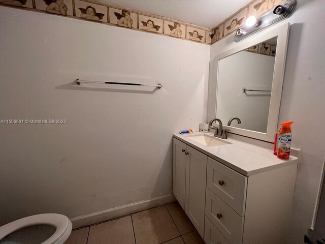 bathroom featuring tile patterned floors, toilet, and vanity