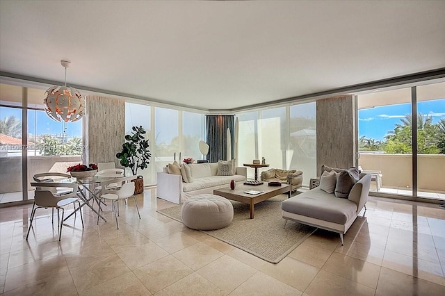 living room featuring a chandelier, plenty of natural light, and light tile floors