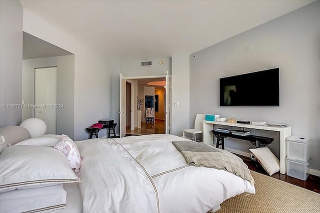 bedroom with dark hardwood / wood-style floors