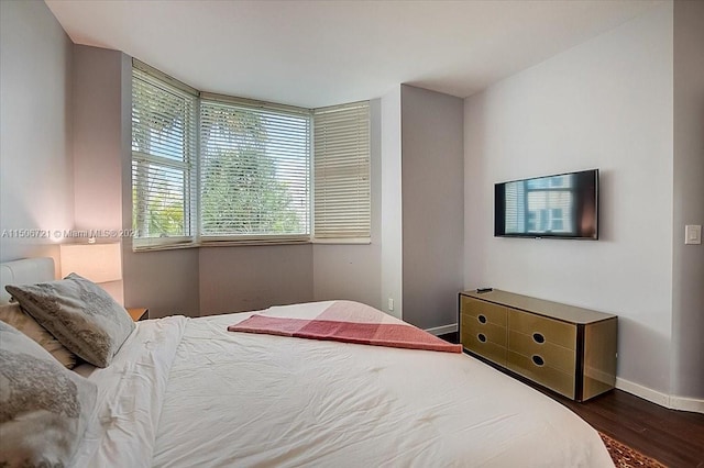 bedroom with dark wood-type flooring