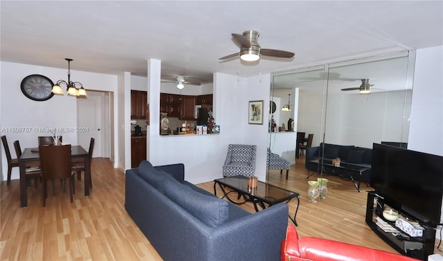 living room featuring light wood-type flooring and an inviting chandelier