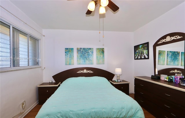 bedroom with ceiling fan and dark wood-type flooring