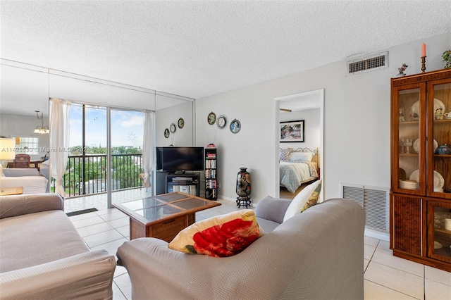 living room with light tile patterned floors and a textured ceiling