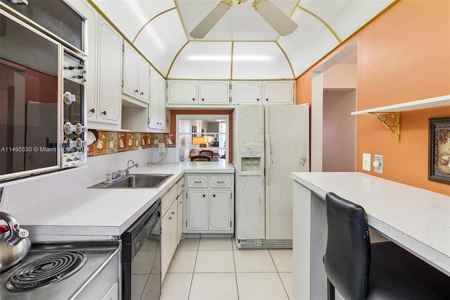 kitchen featuring white refrigerator with ice dispenser, white cabinets, ceiling fan, black dishwasher, and light tile patterned flooring