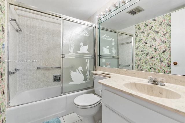 full bathroom featuring shower / bath combination with glass door, tile patterned flooring, vanity, and toilet