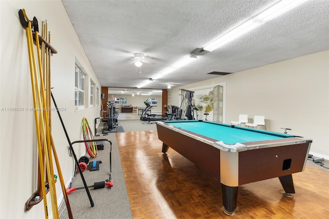 recreation room featuring ceiling fan, parquet floors, and a textured ceiling