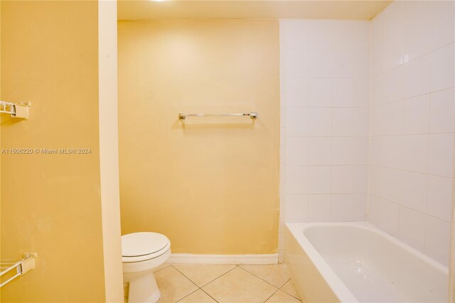 bathroom featuring toilet and tile patterned flooring