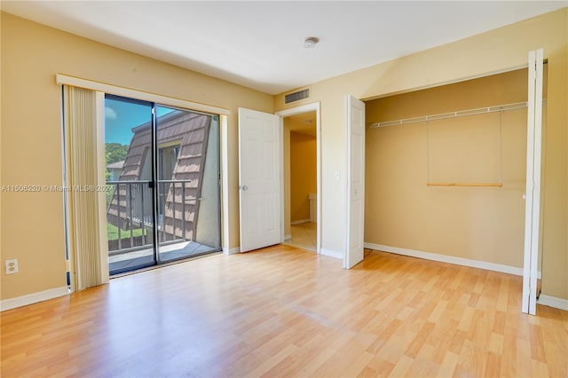 unfurnished bedroom featuring access to outside and light wood-type flooring