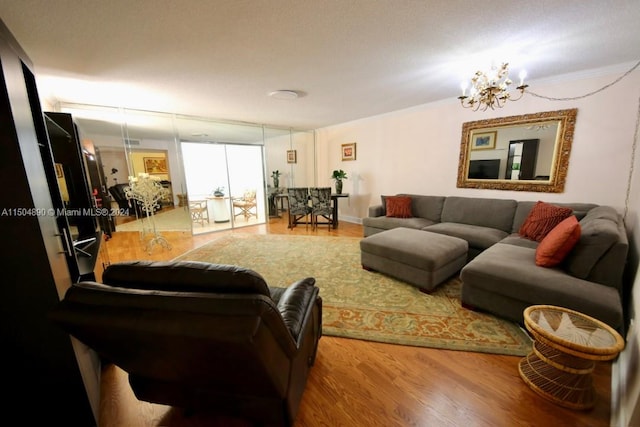 living room with hardwood / wood-style floors, an inviting chandelier, and ornamental molding