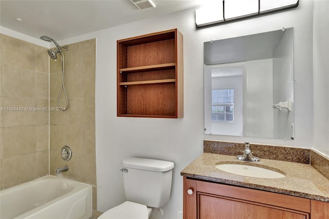 full bathroom with tiled shower / bath, built in features, toilet, and large vanity