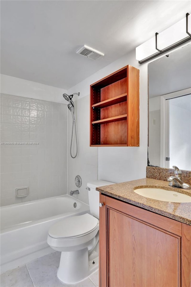 full bathroom featuring tiled shower / bath, tile flooring, toilet, and vanity