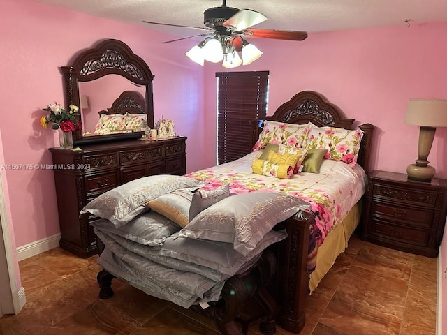 tiled bedroom featuring ceiling fan