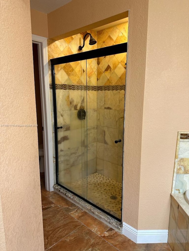 bathroom with tile patterned flooring and a shower with door