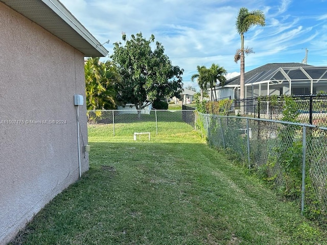 view of yard with glass enclosure