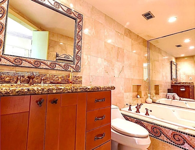 bathroom featuring tile walls, toilet, and vanity