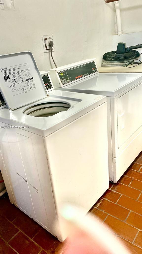 washroom with washing machine and clothes dryer