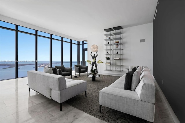 living room with a wall of windows and a water view