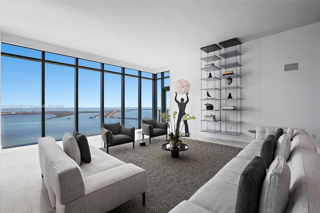 living room featuring a water view, a wall of windows, and light tile floors