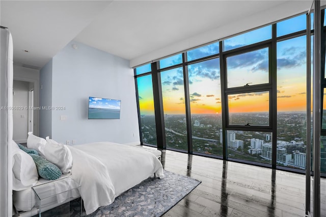 bedroom with hardwood / wood-style floors and multiple windows