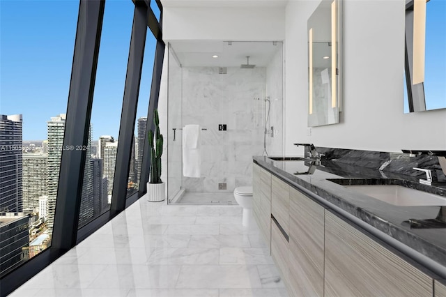 bathroom with toilet, tile floors, a shower with shower door, and double sink vanity