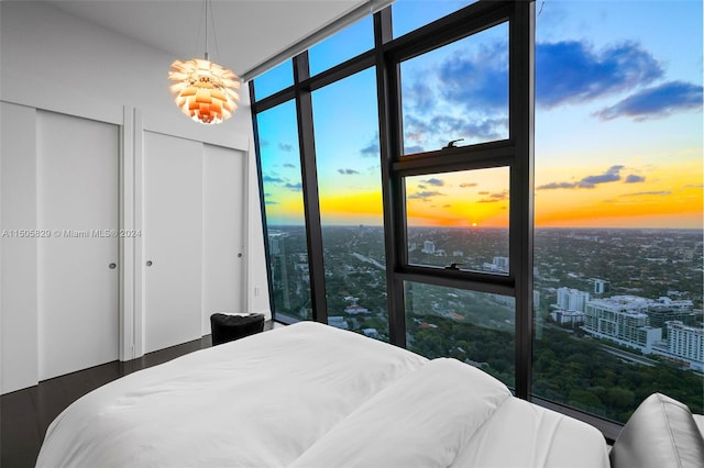 bedroom featuring a chandelier and a wall of windows