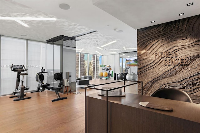 interior space featuring light wood-type flooring and a wall of windows